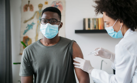 black patient man getting vaccine face mask covid coronavirus